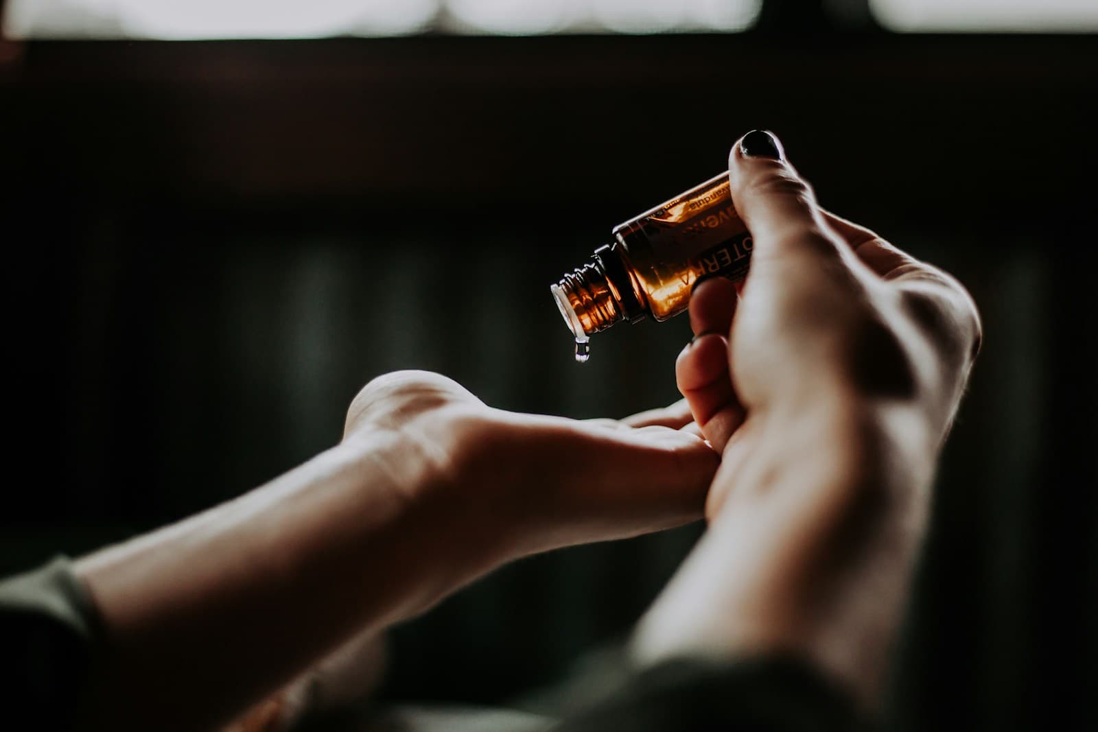 Serum dropper bottle held over a hand